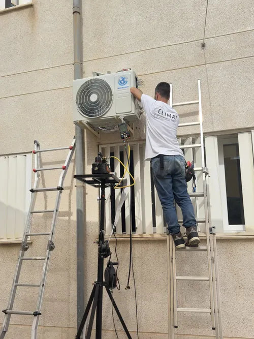 Tecnico de Climai Group instalando una unidad exterior en fachada